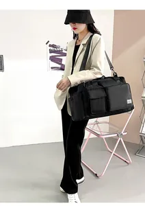 Black waterproof nylon travel bag with crossbody strap and large capacity for gym or travel