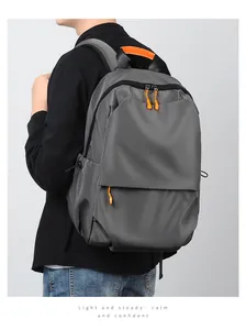 Detail of grey waterproof laptop backpack with orange accents and adjustable side straps