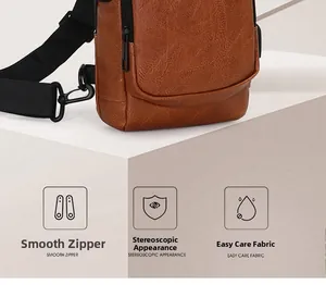 Detail of brown leather chest bag with litchi texture and smooth metal zipper closure