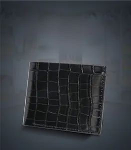 Detail of the black crocodile pattern texture and premium finish on a men's wallet