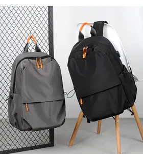 Detail of high-density nylon backpack with vibrant orange zippers and side drawstring pocket