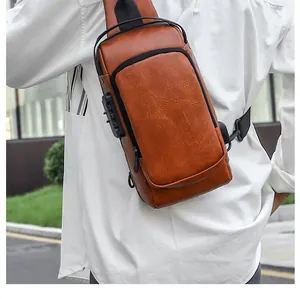 Detail view of brown leather chest bag with security lock and USB charging port