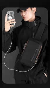 Detail of black chest bag with built-in USB charging port and anti-theft combination lock