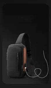 Detail view of water-resistant chest bag featuring a built-in USB port and anti-theft lock