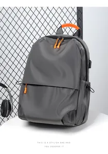 Detail view of water-resistant gray laptop backpack with USB port and orange accents