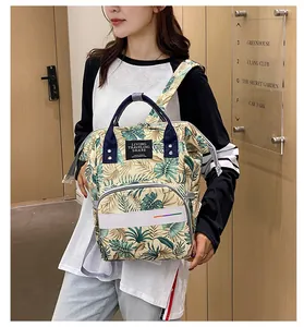 Detail view of large capacity diaper backpack with green tropical leaf prints