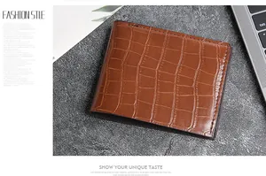 Close-up of brown crocodile pattern men wallet on a stylish office desk background