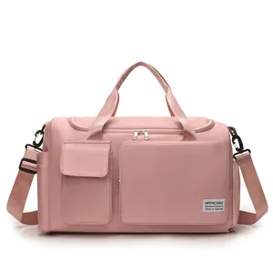 Front view of pink nylon travel bag with multiple pockets and detachable shoulder strap