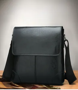Macro view of black leather messenger bag with pebble grain texture and light business style