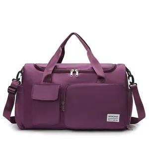Detailed view of purple nylon travel bag featuring multiple pockets and detachable strap