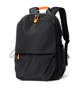 Detail of waterproof nylon backpack with orange zippers and external USB charging port