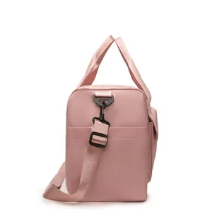 Macro detail of dusky rose travel bag featuring durable nylon fabric and side pocket