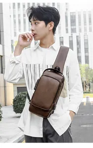 Detail of vintage brown leather sling bag with security lock and external USB port