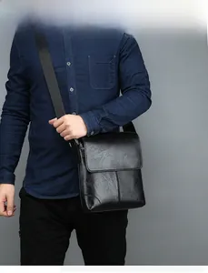 Mens black crossbody bag in polished oil wax leather with adjustable shoulder strap