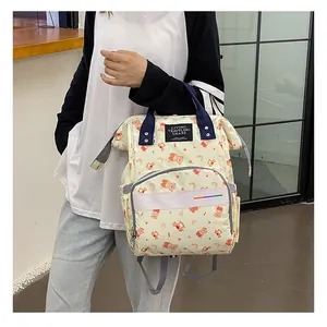 Close-up of waterproof diaper bag showing cartoon bear prints and navy blue top handles