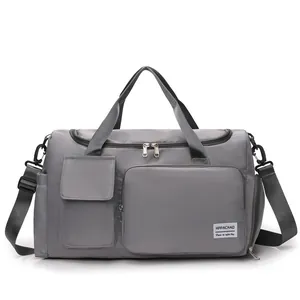 Detailed shot of dark gray nylon travel bag with reinforced handles and silver hardware