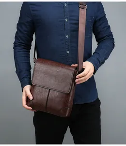 Detailed view of brown waterproof leather cross-body bag texture with adjustable strap