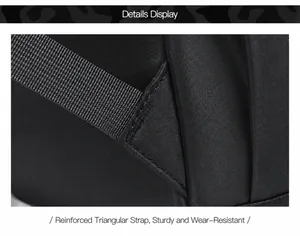 Close-up of reinforced triangle stitching on black durable nylon backpack shoulder straps