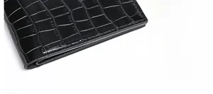 Detailed close-up of crocodile pattern leather stitching and smooth edge oil finish