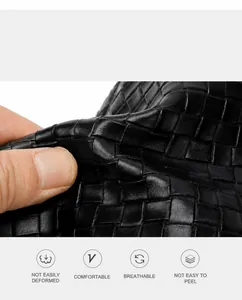 Macro shot of black woven leather texture showing flexibility and premium material detail
