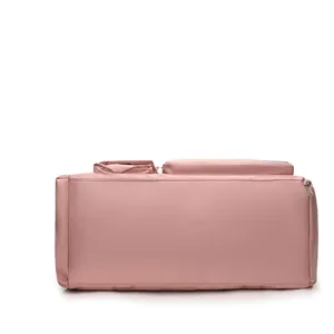 Detailed side view of water-resistant light pink travel bag with reinforced seams and side pockets