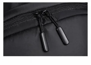 Detailed close-up of premium smooth double zippers on black nylon business backpack