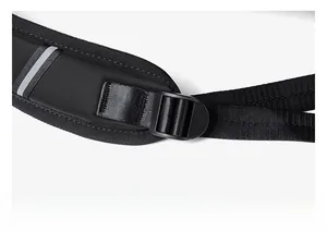 Detail of adjustable padded shoulder strap with reflective safety strip on black backpack