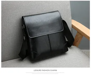 Detailed close-up of textured black PU leather messenger bag with flap cover and strap