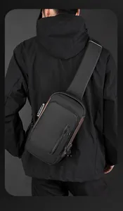 Close-up of black crossbody bag with anti-theft combination lock and waterproof fabric