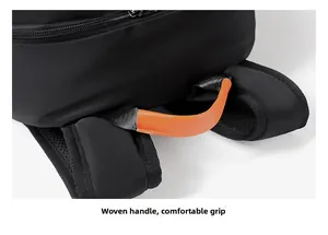 Detail of the woven orange handle and breathable padded mesh straps on the black backpack