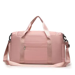 Macro detail of a pink waterproof nylon travel bag with reinforced straps and zippers