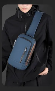 Detail of navy blue men chest bag with anti-theft lock and external USB charging port
