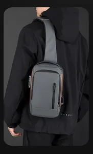 Detail view of water-resistant fabric with anti-theft lock and USB port on gray sling bag