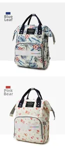 Detail view of large capacity diaper backpacks in Blue Leaf and Pink Bear patterns