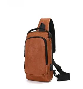 Detailed side view of brown leather chest bag showing USB charging port and textured PU finish