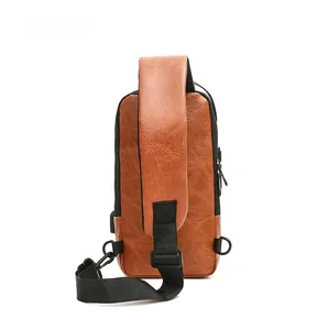 Detail of vintage brown leather chest bag with USB charging port and adjustable D-rings