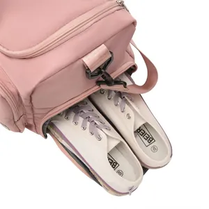 Pink waterproof fitness bag featuring a dedicated bottom compartment for sports shoes