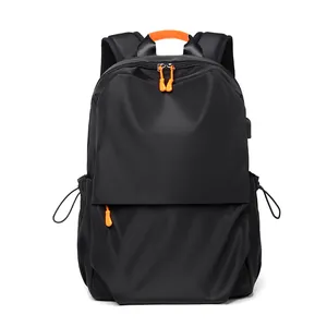 Large black backpack with orange accents and USB port for travel and school use