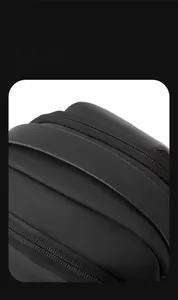 Close-up of black matte multi-layer compartments and smooth zipper of the crossbody bag