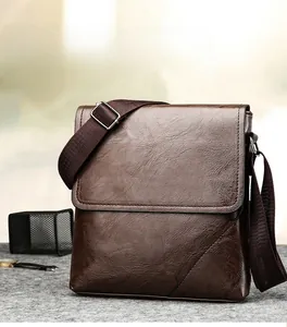 Detailed view of the dark brown leather texture and stitching on men's crossbody bag