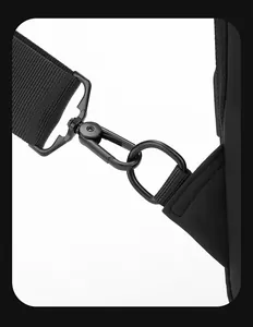 Macro shot of durable black fabric shoulder strap with rotating matte metal hook and D-ring