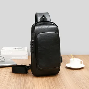 Men's black leather chest bag with anti-theft lock and USB port on a wooden table