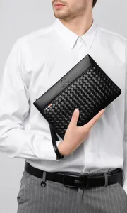 Detail of men's woven leather clutch featuring kangaroo logo and wrist strap detail