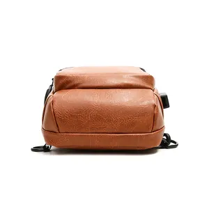 Brown vintage PU leather chest bag for men with USB charging port and sturdy bottom stitching