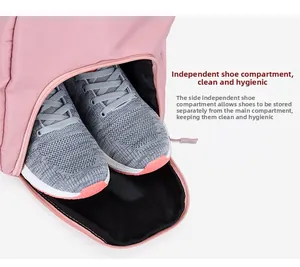 Detail view of the independent shoe compartment on a pink fitness travel bag