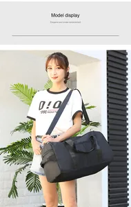 Detail view of black travel bag showing durable handles and adjustable shoulder strap