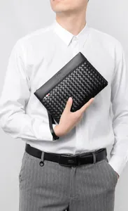 Detail of black woven texture business clutch with logo and signature ribbon strap