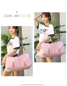 Pink waterproof travel bag showing adjustable shoulder strap and gold hardware detail