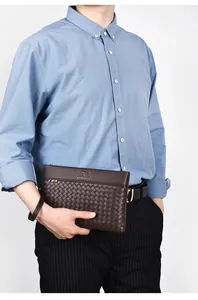 Detail of dark brown woven leather business clutch with kangaroo logo and wrist strap