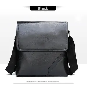 Detail shot of the black PU leather texture and stitching on this men's crossbody bag